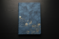 Journal with black wooden table background